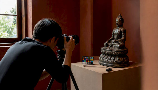 Photographer preparing to shot antique bronze Buddha sculpture