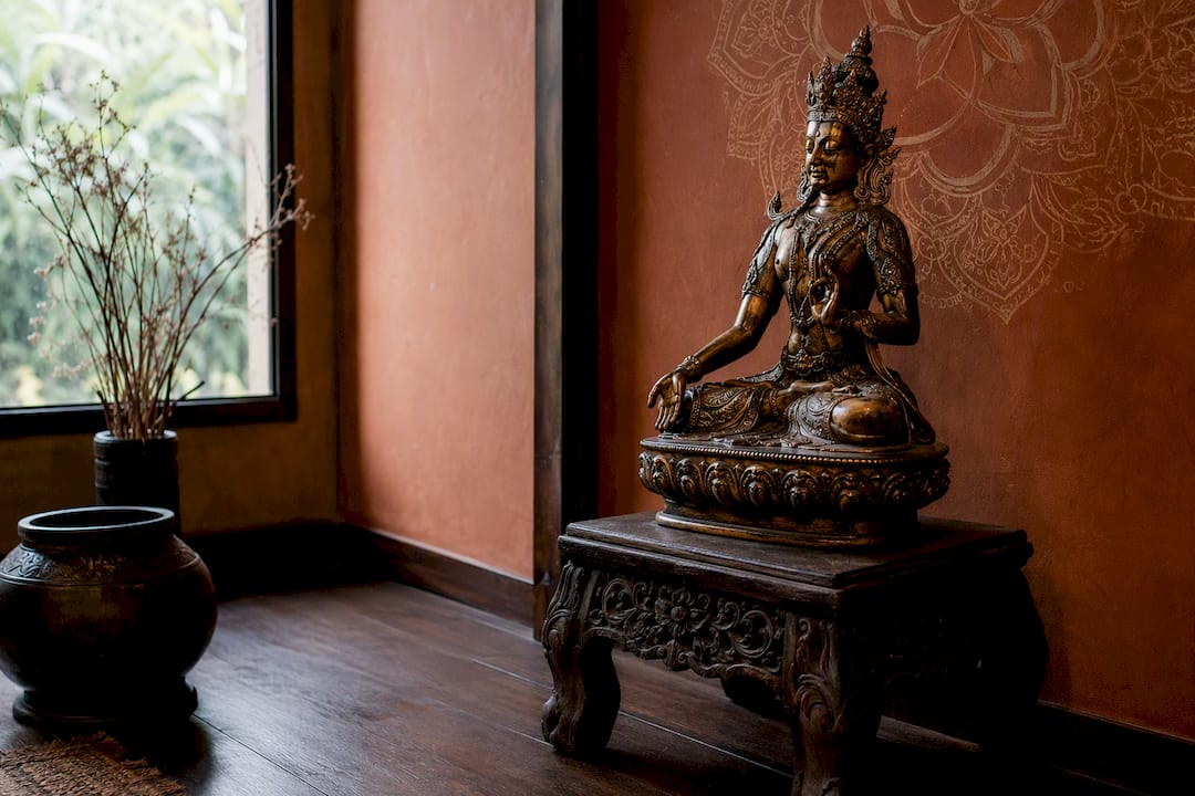 Bronze deity sculpture in elegant office corner