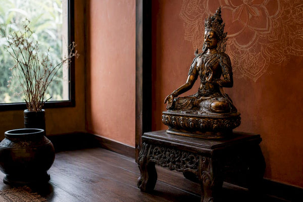 Bronze deity sculpture in elegant office corner